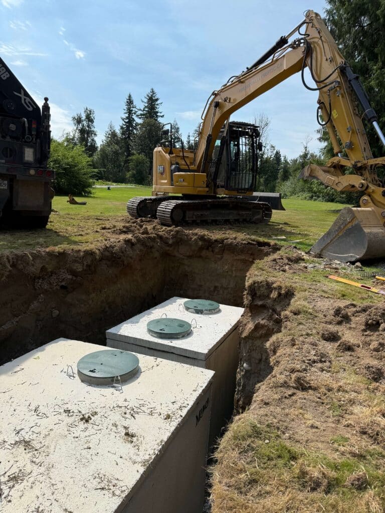 Fast septic tank service crew and their excavator stand ready next to a newly installed septic tank system in Langley.